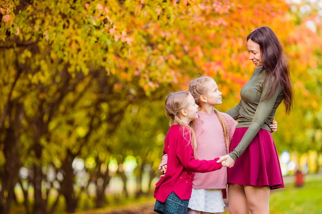 Kleines Mädchen mit Mutter draußen im Park am Herbsttag