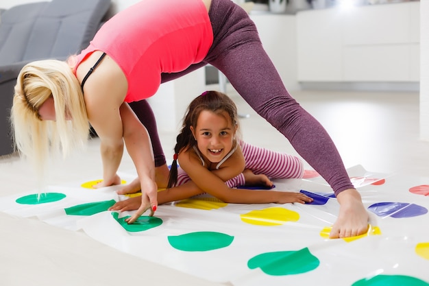 kleines Mädchen spielt Twister zu Hause