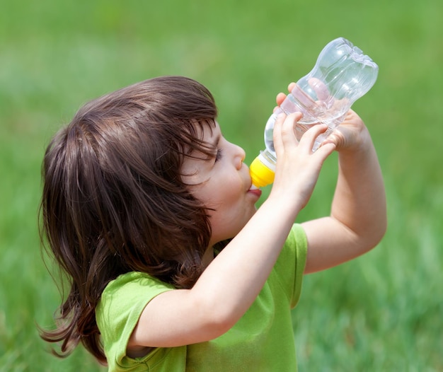 Kleines Mädchen trinkt Wasser aus einer Flasche