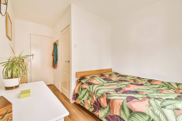 Kleines Schlafzimmer mit Regal und Türen der Pflanze