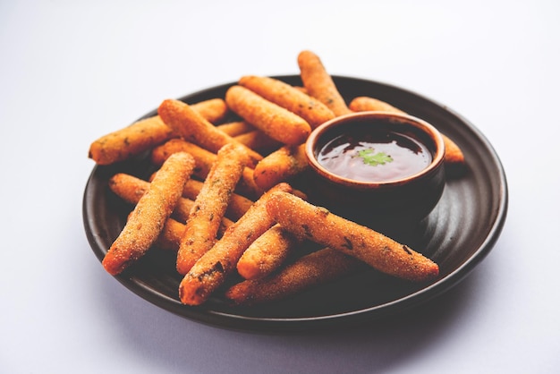 Knusprige Rava-Aloo-Finger oder gebratene Fingerstäbchen aus Kartoffelgrieß, serviert mit Ketchup