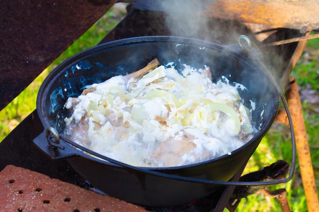 Kochen im Freien in einem Kessel Zubereitung von Speisen am Feuer in einem wilden Camping