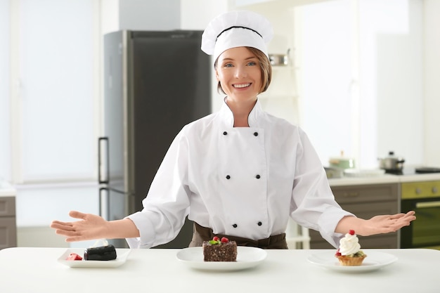 Köchin mit leckeren Desserts in der Küche