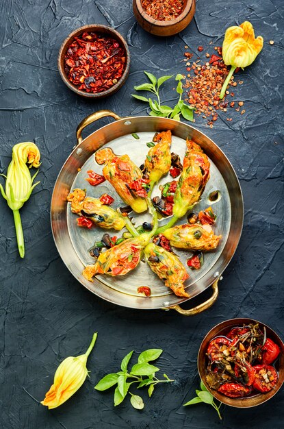 Köstliche gebratene Zucchiniblüten gefüllt mit sonnengetrockneten Tomaten.Sommeressen.