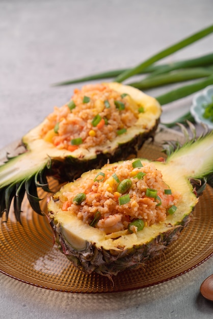 Köstliche geschnitzte Ananas diente als Schüsselbehälterboot, gefüllt mit frischem Reis mit frischen Ananastomaten-Saucen und Meeresfrüchten.