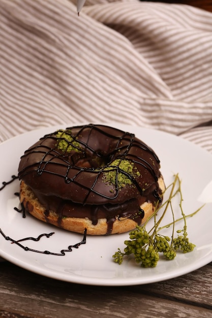 Köstlicher Donut mit Schokoladensauce und Pistazienstückchen