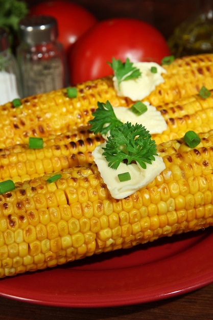 Foto köstlicher goldener gegrillter mais mit butter auf dem tisch auf holzhintergrund