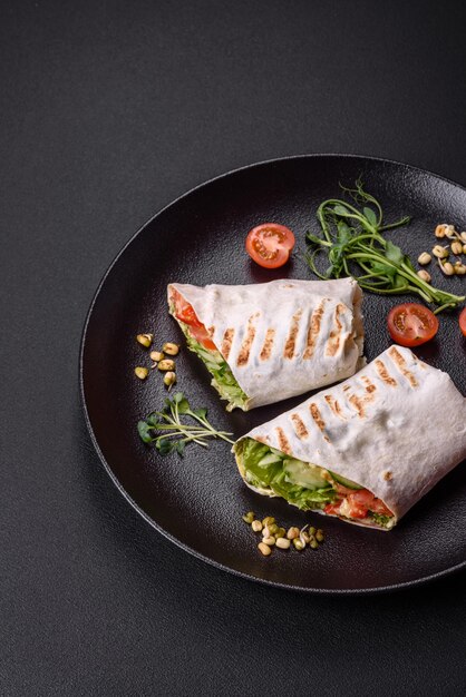 Köstliches frisches Shawarma mit Tomaten-Paprika-Gurken auf dunklem Betonhintergrund