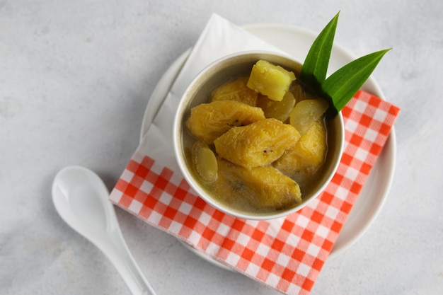 Kolak com Banana Feito de banana cozida com leite de coco, açúcar de palma e folhas de pandanus