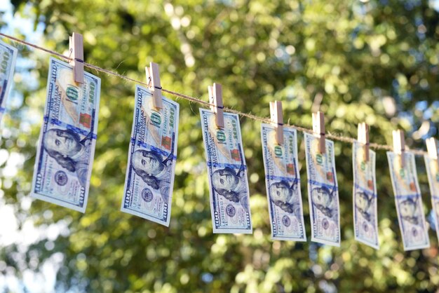Konzept der Geldwäsche hundert Scheine, die im Freien an einem Seil hängen