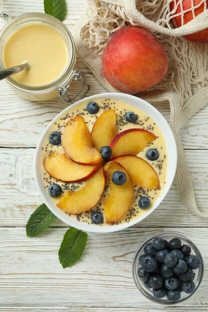 Konzept der gesunden Ernährung mit Pfirsichjoghurt auf weißem Holztisch