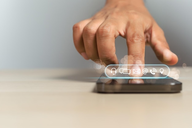 Konzept der Kontaktaufnahme Hand berühren Smartphone-Bildschirm Finger zeigen auf Kontaktsymbole Verbindung Kundenservice E-Mail-Anrufadresse Chat-Nachricht verbinden Senden und Empfangen