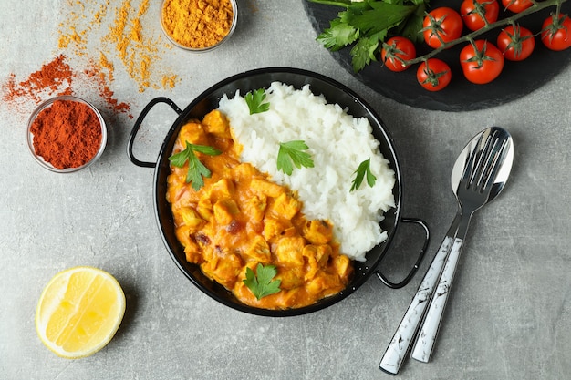 Konzept des leckeren Essens mit Hühnchen-Tikka auf grauem strukturiertem Hintergrund