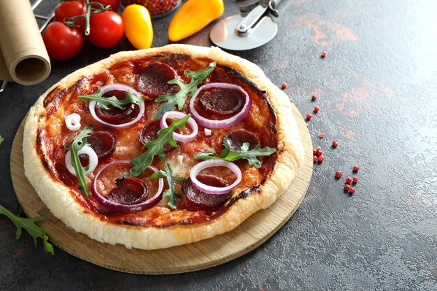 Konzept des leckeren Essens mit Salami-Pizza auf dunklem Tisch