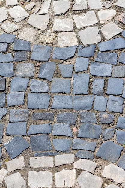 Kopfsteinpflaster der Altstadt Textur Hintergrund Blick von oben auf die Steinstraße Detail Bürgersteig aus Granit