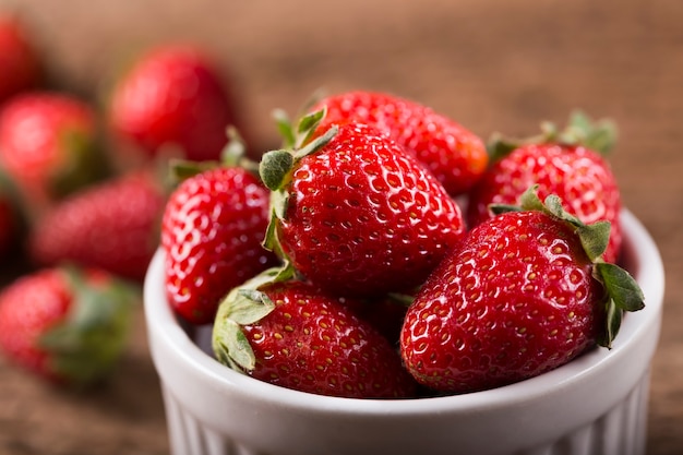 Korb mit frischen Erdbeeren auf Holzuntergrund