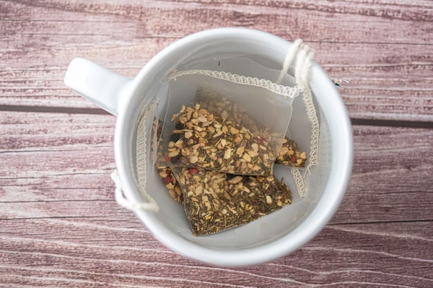 Kräuterteebeutel in Teetasse, um eine Tasse Tee zuzubereiten