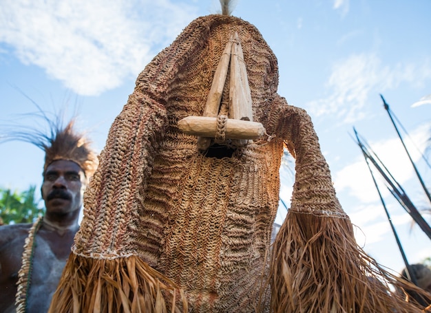 Krieger des Stammes Asmat im Kostüm eines bösen Geistes tanzt einen rituellen Tanz.