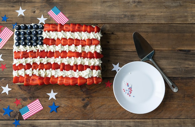 Kuchen mit den Farben der US-Flagge auf einem hölzernen Hintergrund mit weißer Platte Feier zum Unabhängigkeitstag Draufsicht