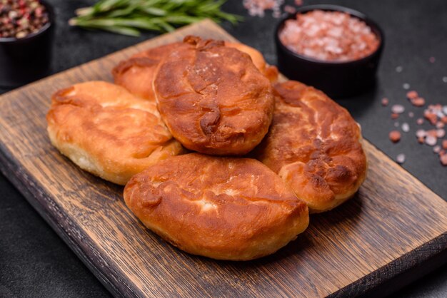 Kuchen mit Kartoffeln auf einem Holzschneidebrett kochen