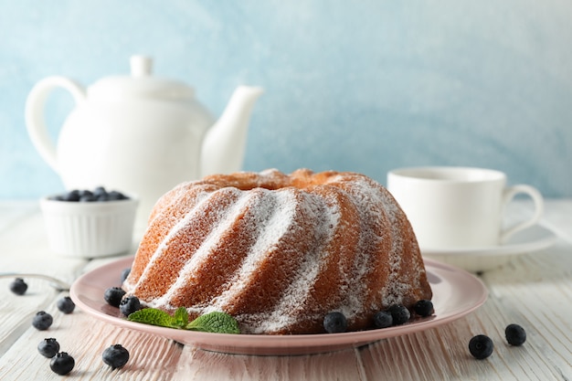 Kuchen mit Puderzucker und Blaubeere auf hölzernem Hintergrund