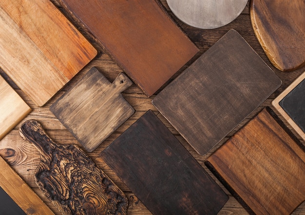 Küchenschneidebretter in verschiedenen Größen und Formen auf Holzhintergrund.
