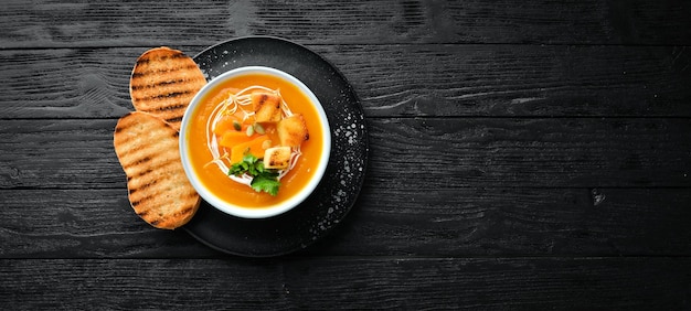 Kürbiscremesuppe in einer Schüssel mit Toastbrot Diätkost Draufsicht Freier Kopierplatz