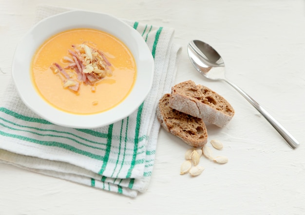 Kürbisgelbe Suppe und organische Kürbiskerne Draufsicht, Kopienraum. Saisonaler Herbst Würziges Essen - leckere und schmackhafte Bio-Ernährung für Feinschmecker