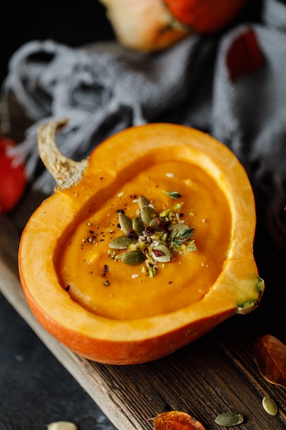 Kürbissuppe im Kürbis. Vegetarische Herbstkürbiscremesuppe mit Samen.