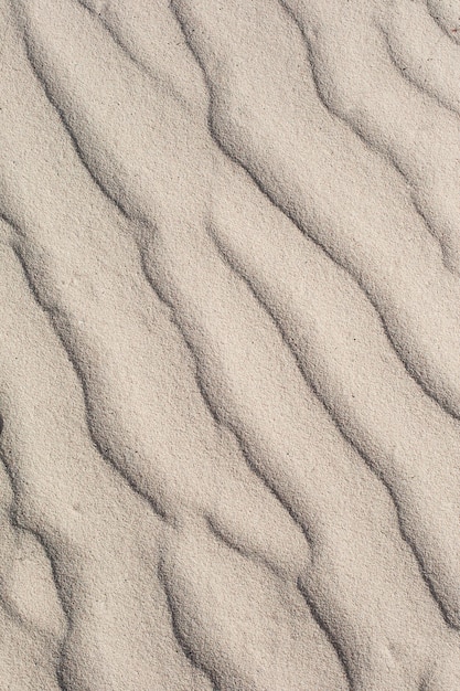 Foto küstenstrand sand wellen textur hintergrund sanddünen tropische küstenlandschaft