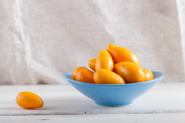 Kumquats en un plato azul