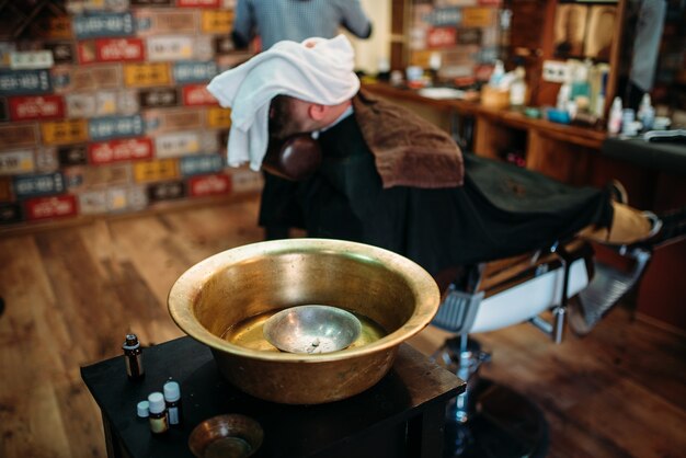 Kupferbecken und Rasierwerkzeuge auf dem Tisch im Friseursalon.