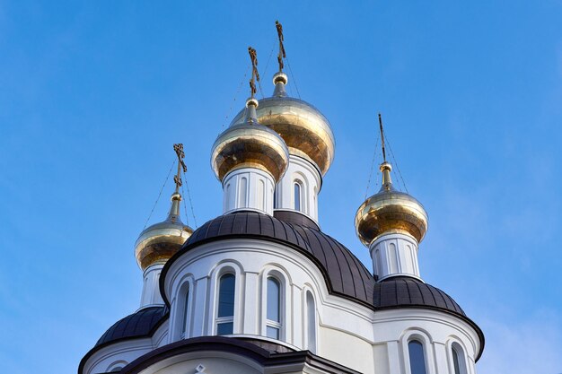 Foto kuppeln und kreuze der christlichen kirche gegen den blauen himmel