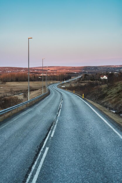 Foto kurvenhafte asphaltstraße mit strompylon inmitten des vulkanfeldes im herbst in island