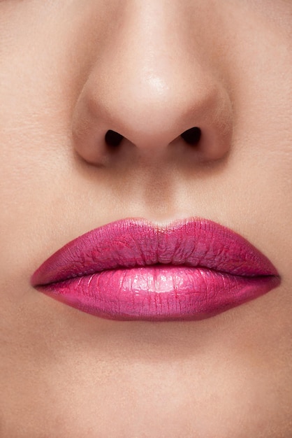 Labios con pintalabios rosa en una foto de cerca. Skink perfecto con hermosos labios. Cosméticos y maquillaje