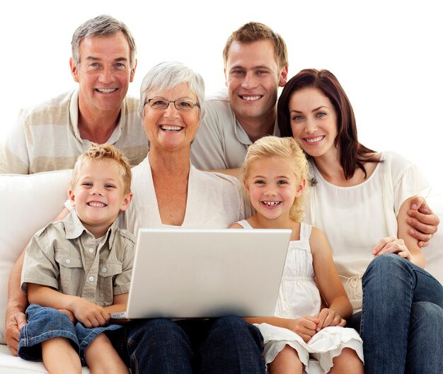 Lächelnde Familie, die zu Hause einen Laptop verwendet