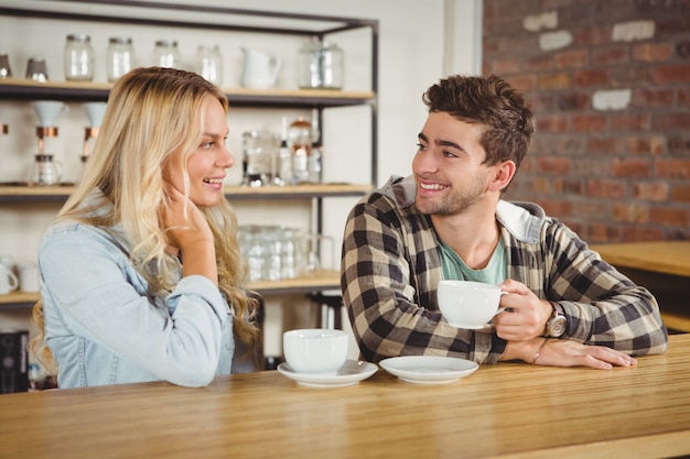 Lächelnde Hippies, die zusammen Kaffee sitzen und genießen