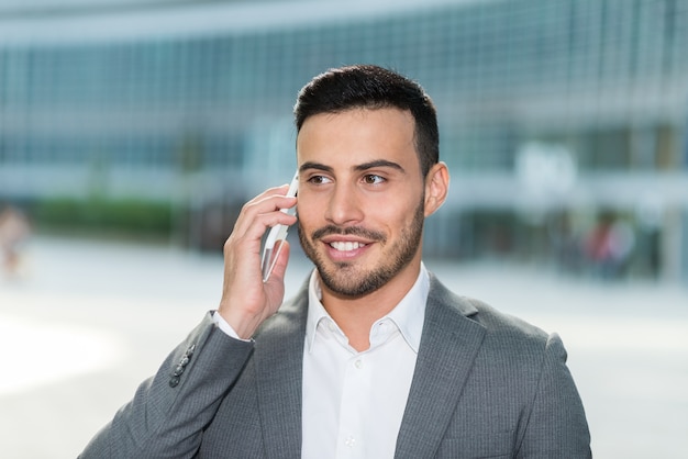 Lächelnder Mann, der am Handy spricht