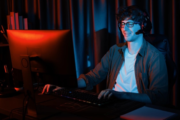 Lächelnder Streamer mit Joystick konzentriert sich auf das Esport-Team auf dem PC mit härteren Gusher