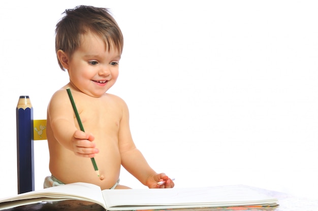 Lächelndes kleines Baby zeichnet vom Bleistift