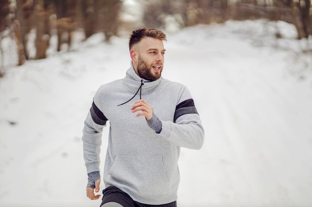 Läufer läuft in der Natur auf Schnee im Winter