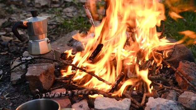 Lagerfeuer brennt im Touristenlager in den Bergen Schönes Lagerfeuer, das Holz am Sommerabend brennt