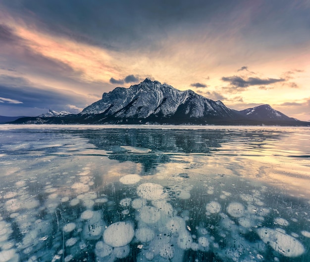 Lago abraham congelado com montanhas rochosas e bolhas naturais congeladas pela manhã no inverno no parque nacional de banff