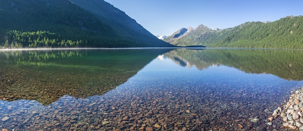 Lago nas montanhas de Altai com belo reflexo em uma manhã de verão