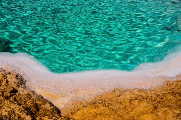 Lago salado con agua turquesa y sal blanca en la orilla cerca del oasis de Siwa, Egipto