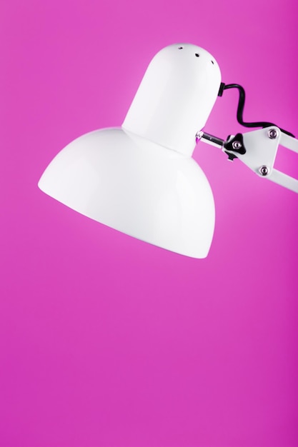 Lâmpada de escritório de mesa branca em fundo rosa com