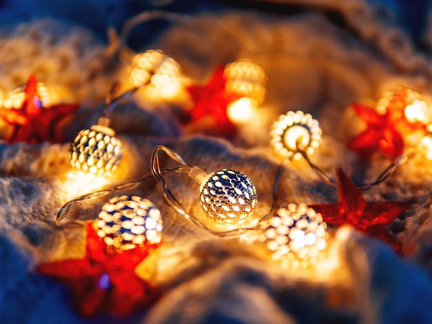 Lâmpadas de malha de Natal e estrelas vermelhas. Decorações de férias aconchegantes.