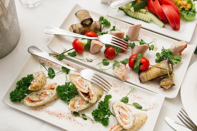 Lanches em pratos brancos em uma mesa de banquete festivo em um casamento. Vista do topo