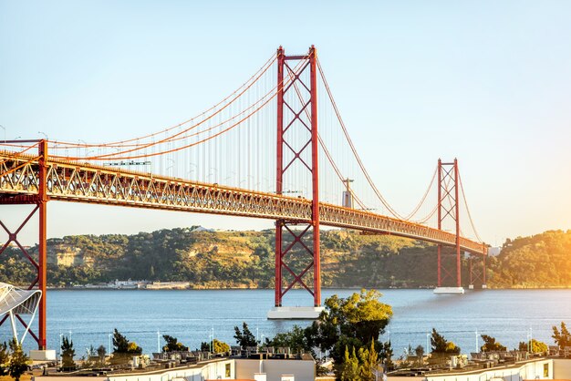 Landschaftsansicht auf der brücke des 25. april während des sonnenuntergangs in der stadt lissabon, portugal