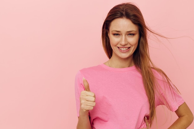 Lange Frisur der schönen Frau in den rosa T-Shirts lokalisierter Hintergrund